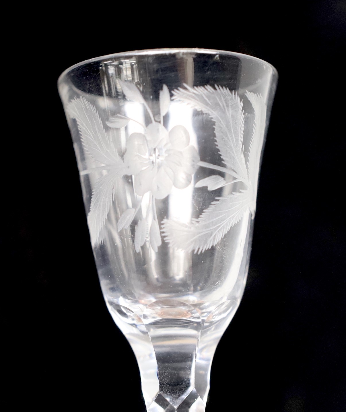A George III facet stem wine or cordial glass, wheel engraved flowers. 16.5cm tall